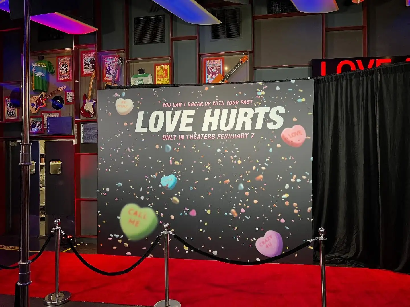 Luxury event step and repeat with gold logos on black background at awards ceremony
